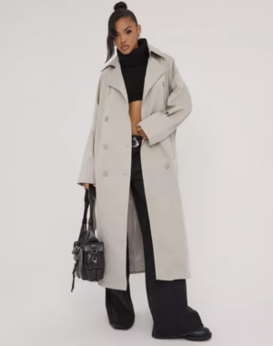 lady wearing black two piece set with stone longline trench coat