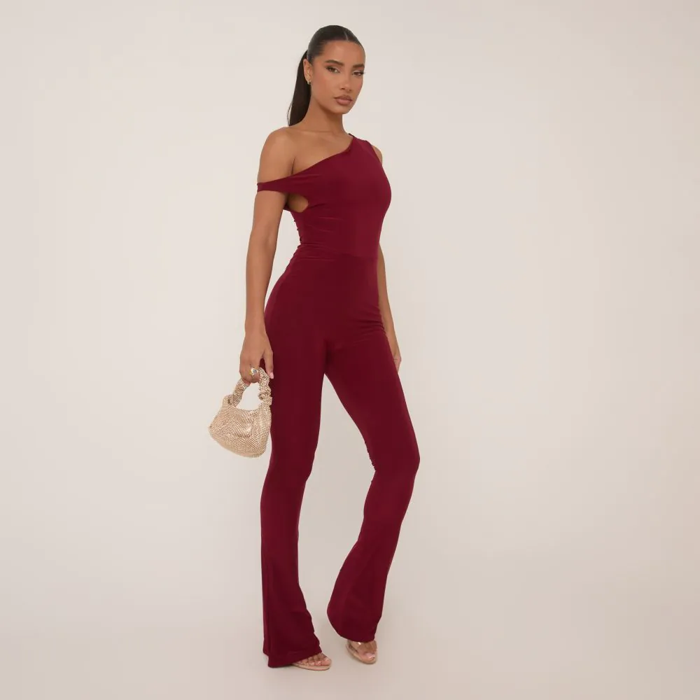 Asymmetric Shoulder Flared Jumpsuit In Burgundy Slinky